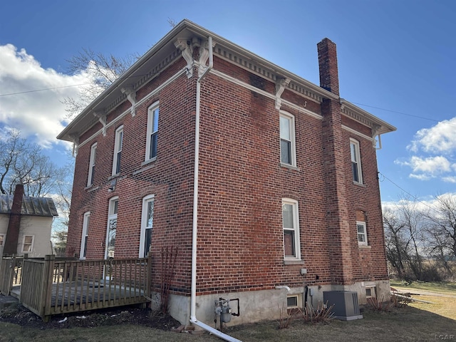 view of side of home featuring central AC unit and a deck