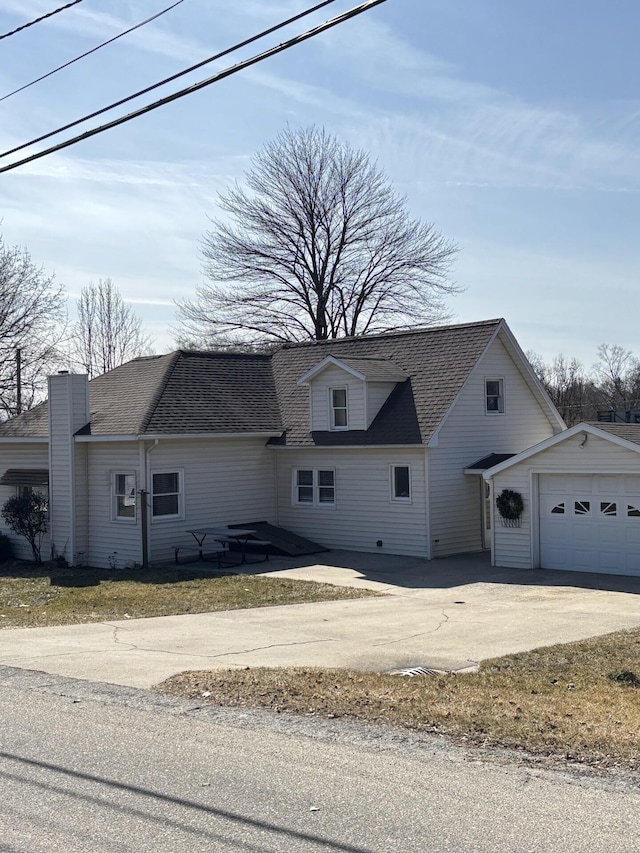 view of home's exterior featuring a garage, driveway, and roof with shingles