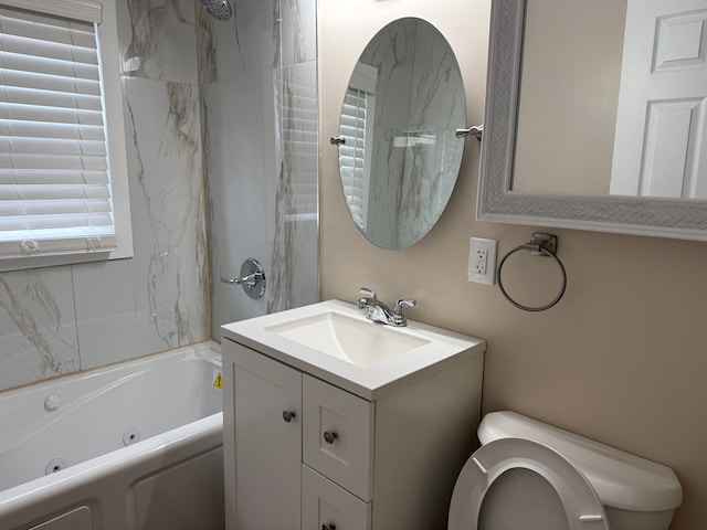 bathroom featuring a combined bath / shower with jetted tub, vanity, and toilet