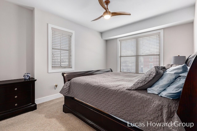 carpeted bedroom with ceiling fan and multiple windows