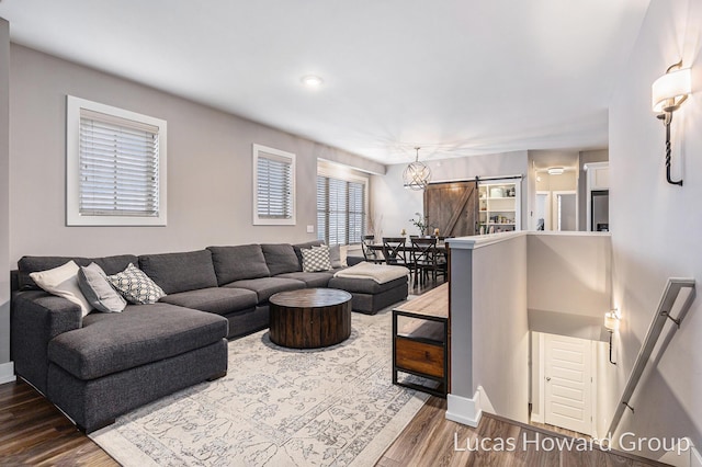 living room featuring dark hardwood / wood-style floors and a barn door