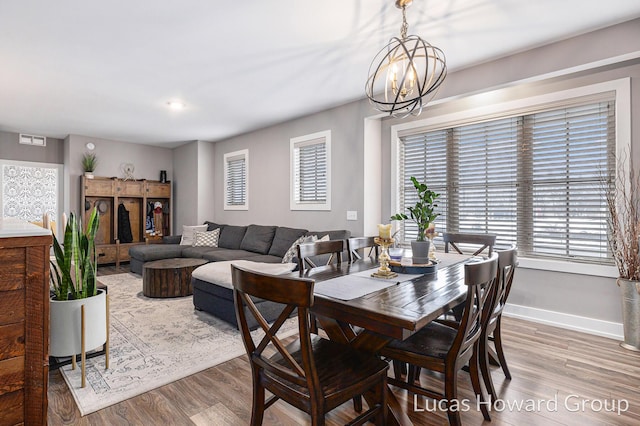 dining room featuring hardwood / wood-style floors and a chandelier