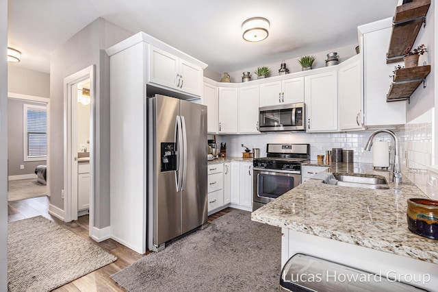 kitchen featuring white cabinetry, sink, and stainless steel appliances