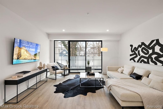 living room with recessed lighting and wood finished floors