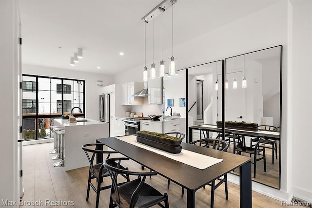 dining area featuring recessed lighting and light wood-style floors