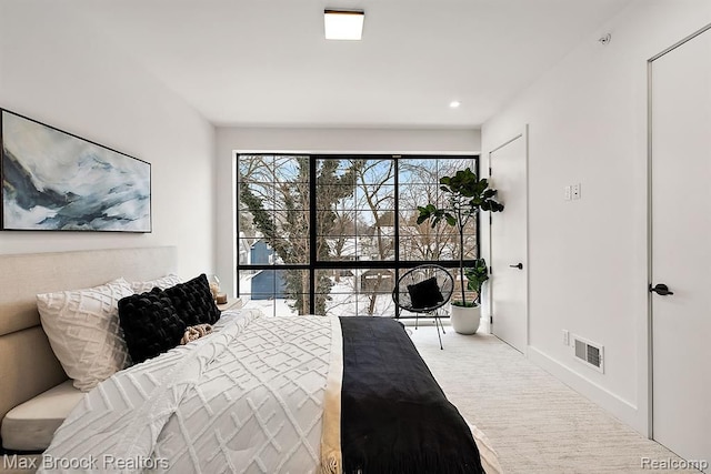 carpeted bedroom featuring baseboards and visible vents