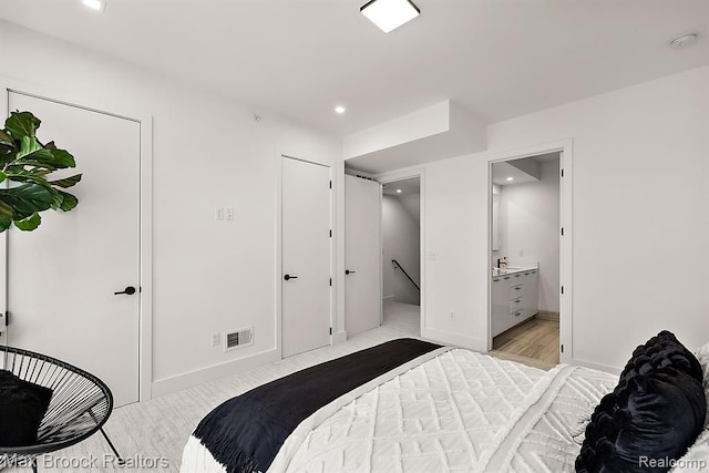 bedroom featuring ensuite bath, recessed lighting, visible vents, and baseboards