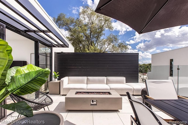 view of patio / terrace with an outdoor living space with a fire pit