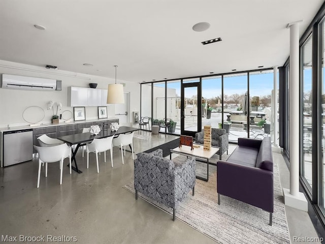 living area with finished concrete flooring, a wall of windows, and a wall unit AC