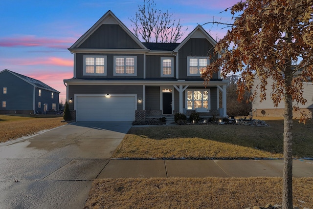 view of front of home featuring a porch, concrete driveway, an attached garage, board and batten siding, and a front yard