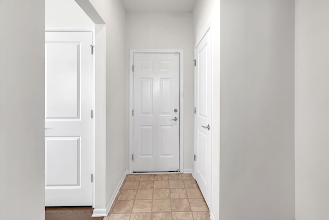 corridor featuring baseboards