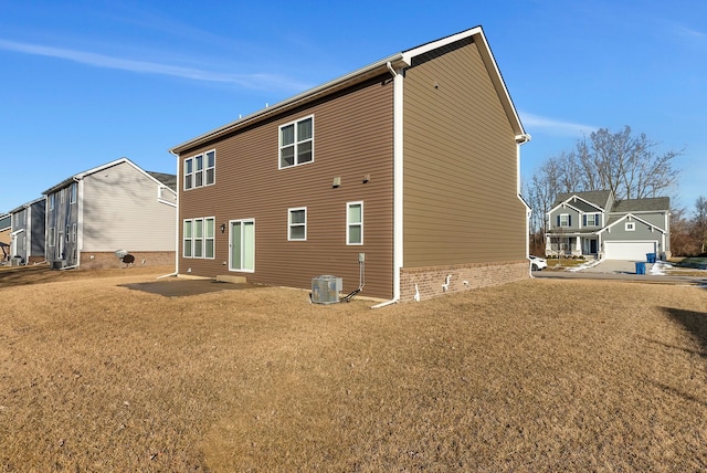 rear view of property featuring a lawn