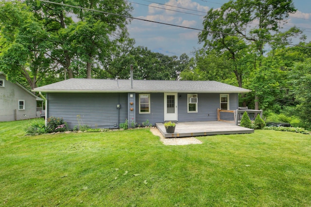 back of house with a deck and a lawn