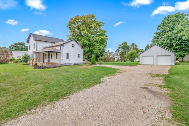 view of home's exterior with a porch, a garage, an outdoor structure, and a yard