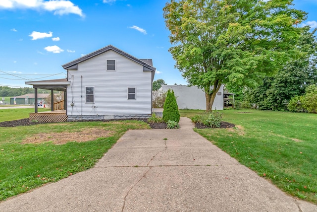view of home's exterior featuring a yard and covered porch