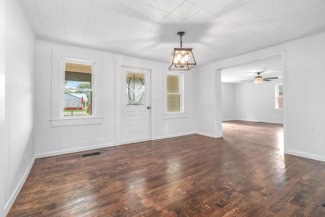 entryway with dark hardwood / wood-style flooring and ceiling fan with notable chandelier