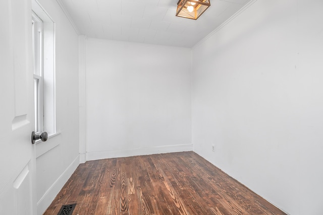 unfurnished room featuring crown molding and dark hardwood / wood-style floors