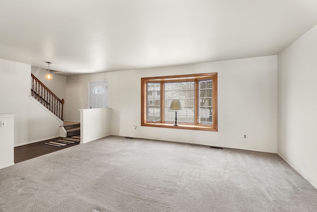 unfurnished living room featuring carpet