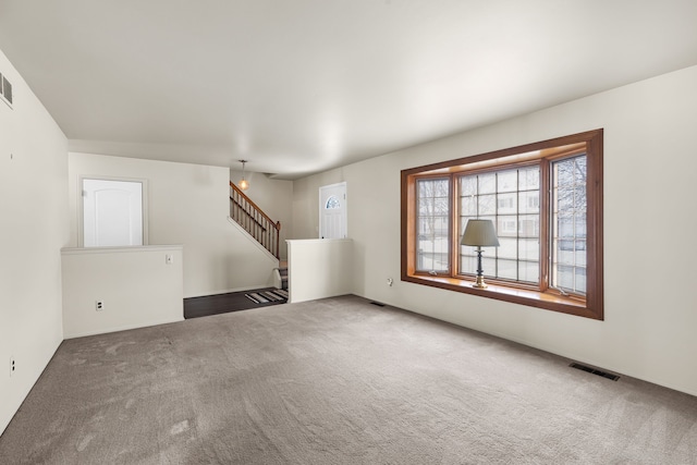 unfurnished living room featuring carpet