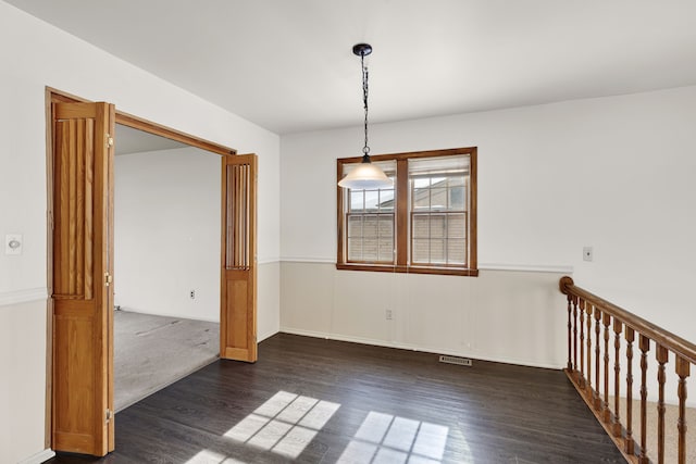 unfurnished room featuring dark hardwood / wood-style flooring