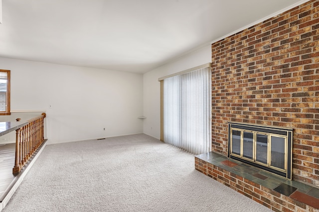 unfurnished living room featuring a fireplace and carpet floors