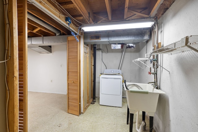 basement featuring washer / dryer and sink