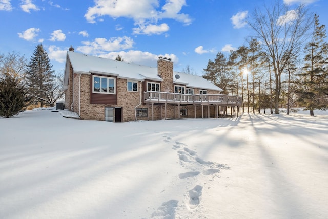 snow covered property featuring a wooden deck