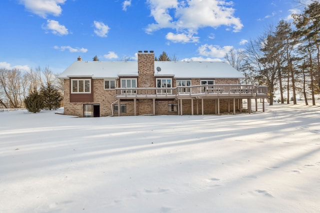 snow covered house featuring a deck