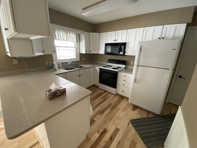 kitchen with white fridge, sink, white cabinets, and electric stove