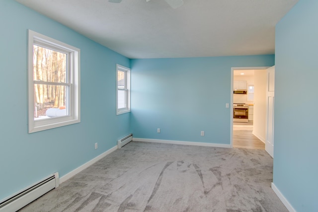 carpeted spare room with a baseboard radiator