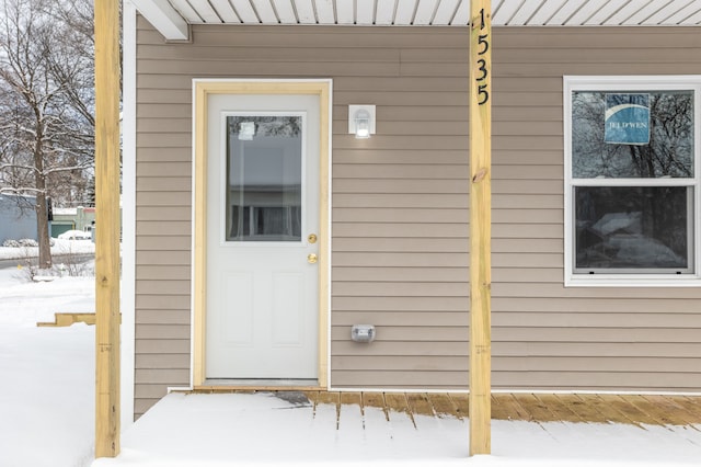 view of snow covered property entrance