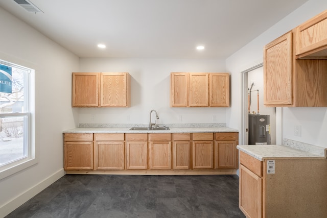 kitchen with sink, electric water heater, and light brown cabinets