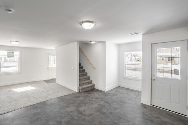 entrance foyer with dark carpet