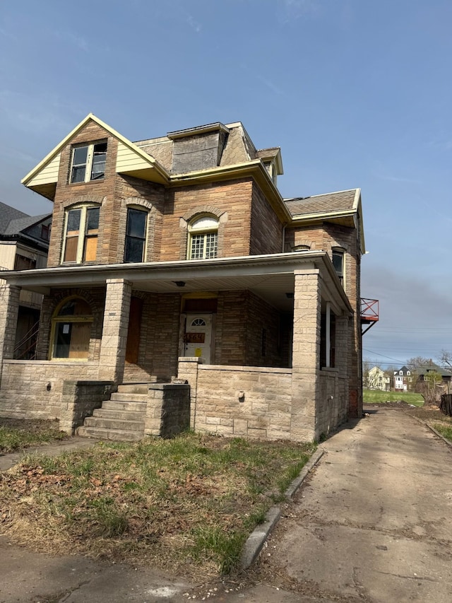 1564 Cadillac Blvd, Detroit, MI 48214 - view of front of house featuring covered porch and stone siding