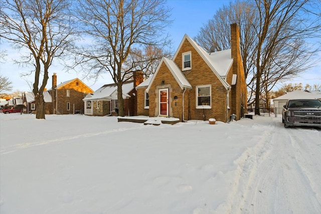 view of front of home featuring brick siding and a chimney