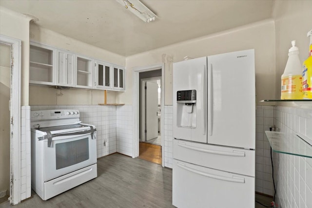 kitchen featuring white appliances, white cabinets, tile walls, and open shelves