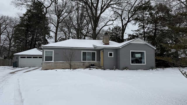 single story home with a garage and a chimney