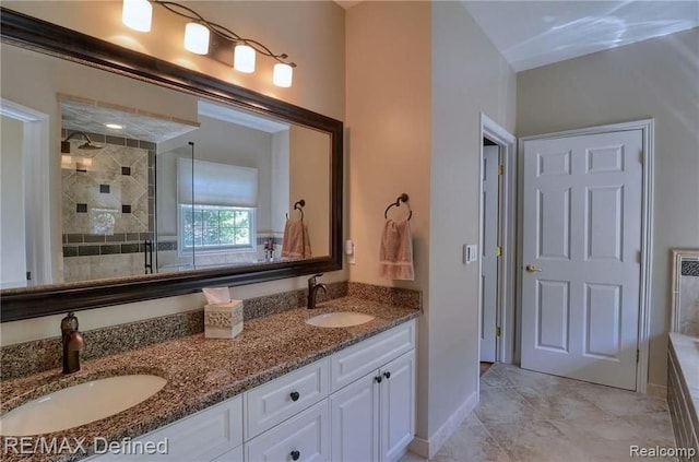 bathroom featuring vanity and a shower with door