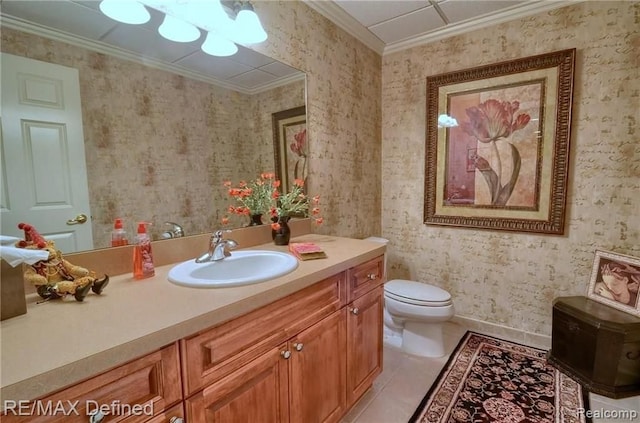 bathroom with vanity, crown molding, tile patterned floors, and toilet