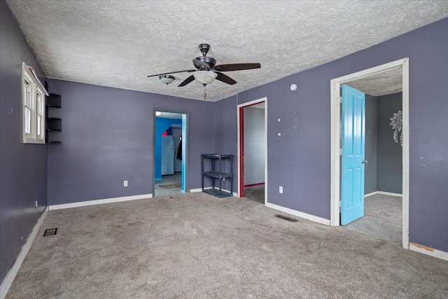 empty room featuring carpet flooring, visible vents, and baseboards