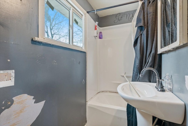 bathroom with a sink and bathing tub / shower combination