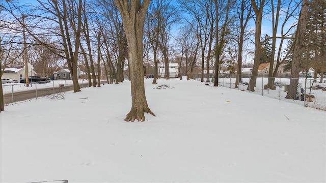 yard layered in snow featuring fence