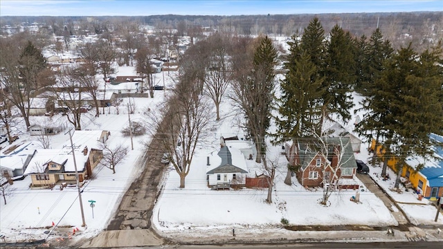 snowy aerial view with a residential view