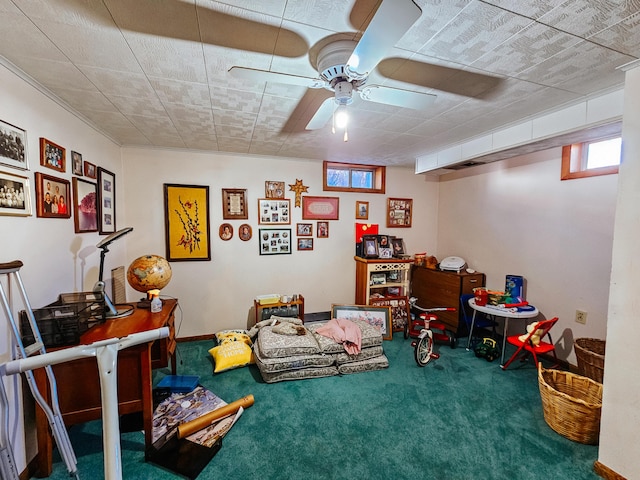 recreation room with ceiling fan and carpet