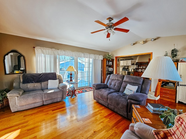 living room featuring vaulted ceiling, ceiling fan, and light hardwood / wood-style floors