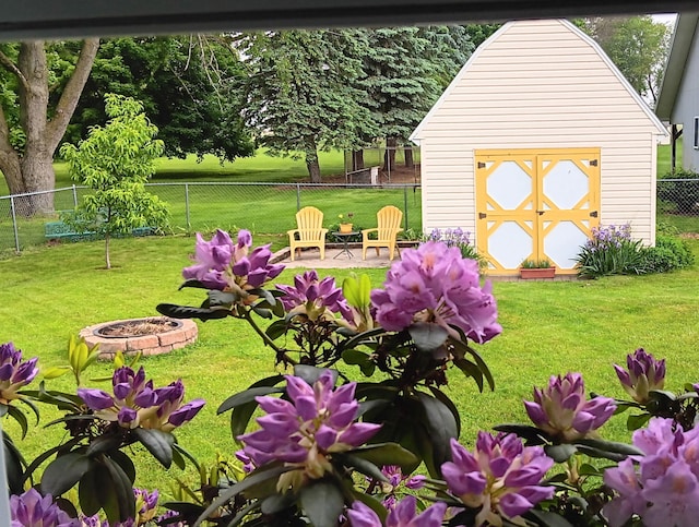 view of yard with a storage shed and a fire pit