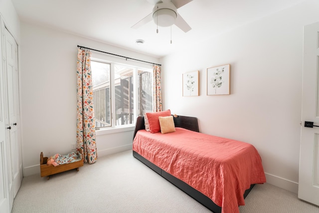 carpeted bedroom with a ceiling fan, baseboards, and a closet