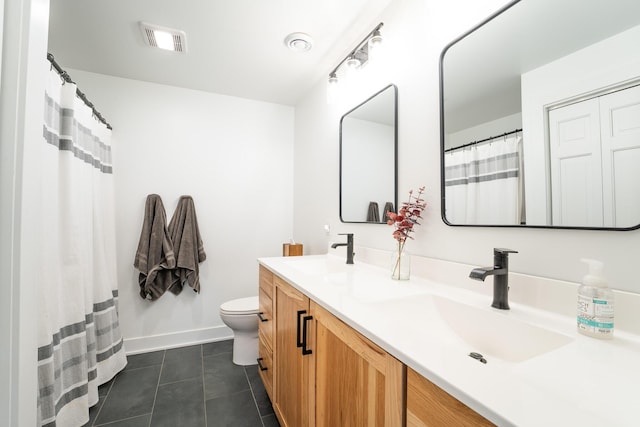 full bath with double vanity, a sink, visible vents, and tile patterned floors