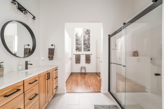 full bathroom with a shower stall, tile patterned flooring, and vanity