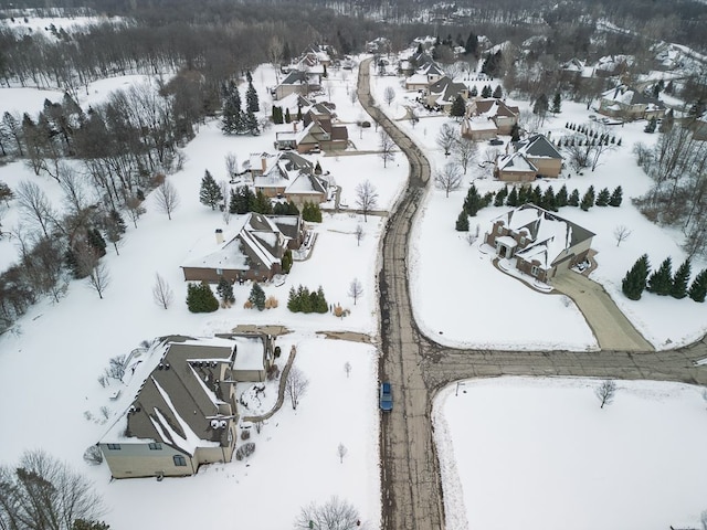 snowy aerial view with a residential view